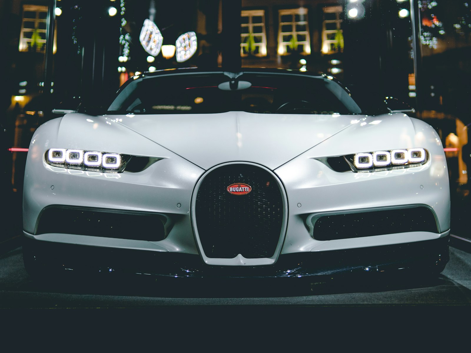 Luxury car arriving at a venue at night