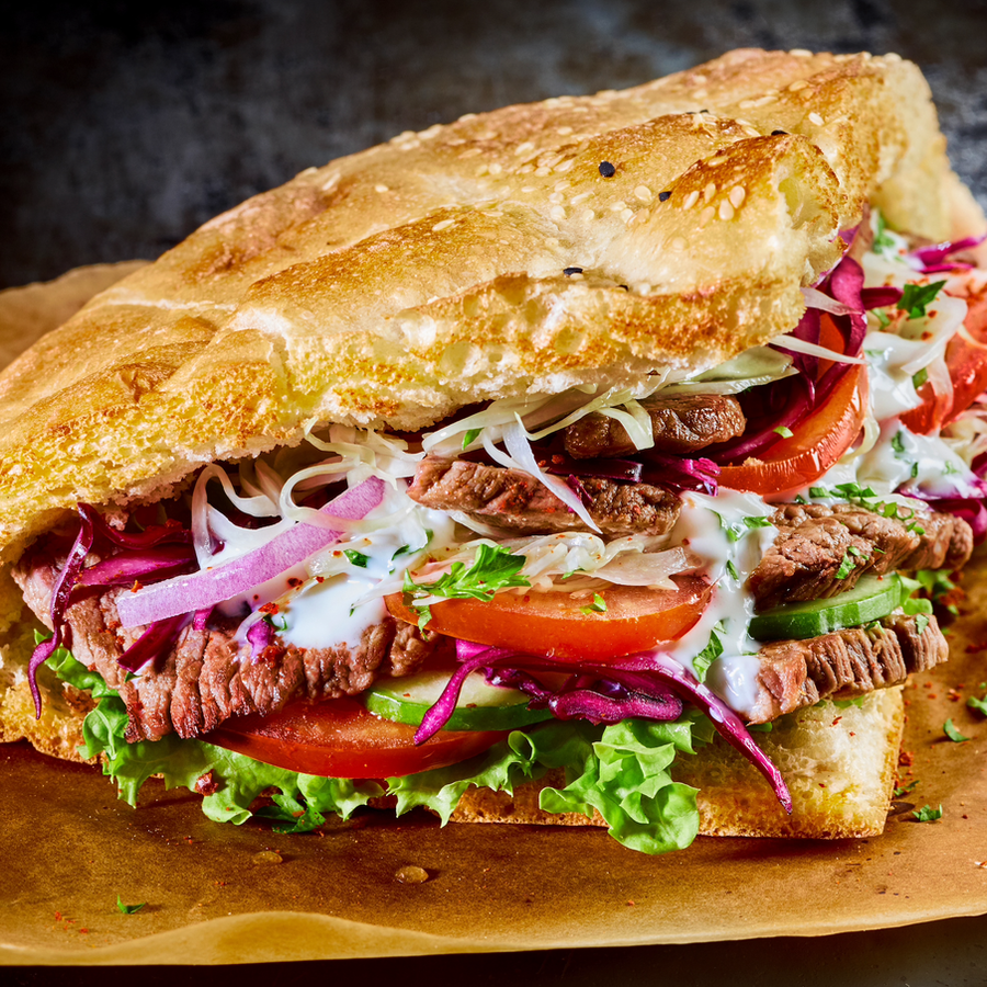 Berliner Haus doner sandwich on Berlin style pide with beef and lamb, tomato, cucumber, and garlic sauce